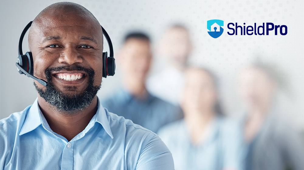 Man in blue shirt and a big smile with headset